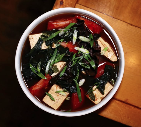 Gull valley tomaotes hojicha mushroom broth with tofu and wakane with green onions and nori salt.png